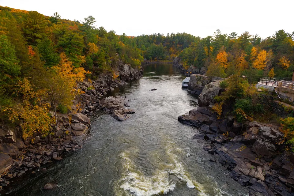 Breathtaking autumn river landscape in Taylors Falls, Minnesota, showcasing vibrant fall colors.