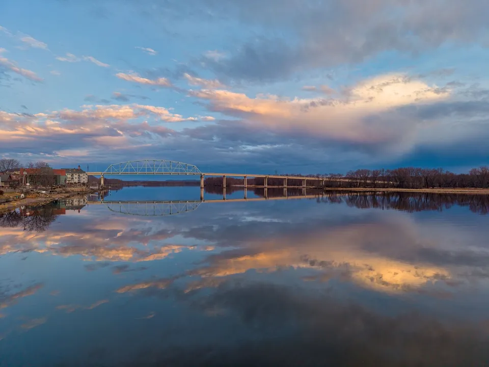 Beautiful sunrise reflections on the Mississippi River in Wabasha, Minnesota, showcasing a tranquil early morning scene.