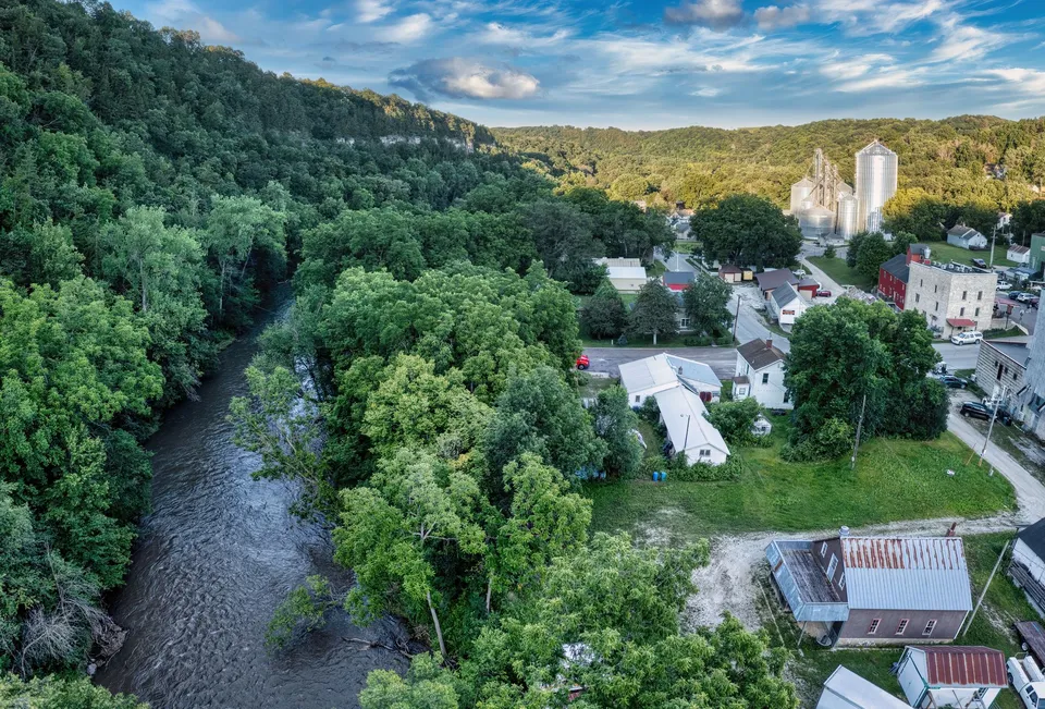 A picturesque aerial view of Lanesboro, MN, showcasing lush greenery and a flowing river.