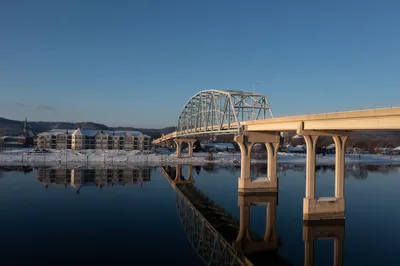 A serene winter view of Wabasha bridge reflecting in Mississippi River.