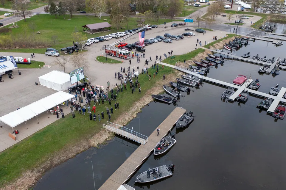 Aerial view of a community gathering at Wabasha Marina with boats and tents.